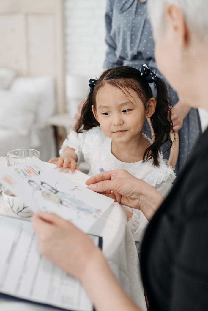 A social worker and a child bonding over drawings in a foster care setting.